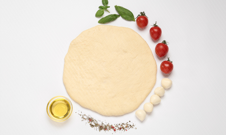 Raw dough and other ingredients for pizza on white background, top view