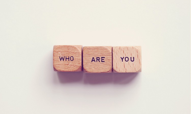 "who are you" spelled on small wooden cubes